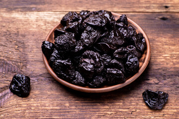 Dried prunes on a wooden background. Dry fruits.