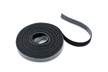 Slim hook and loop tape or velcro rools for cables on white background.