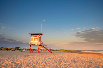 Parnu beach in Estonia during sunny summer sunset, life guard tower in foreground