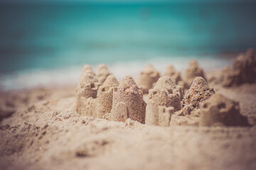 Fototapeta na wymiar Sand castle standing on the beach. Travel vacations concept.