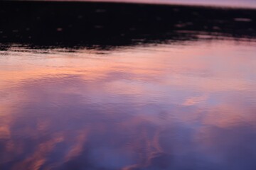 reflection of pink sunset light on the river