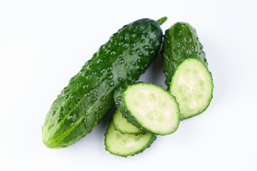 Set of fresh whole and sliced cucumbers on white background. Garden cucumber green wallpaper backdrop design