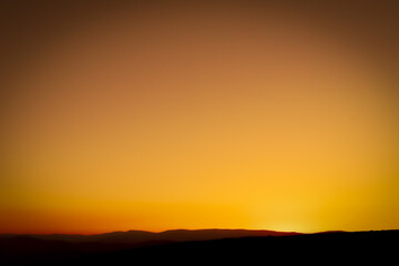 Background of a golden and red sunset in the mountain