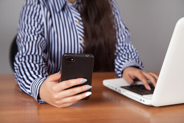 Business woman is busy with her works. He has a mobile phone in his hand.
