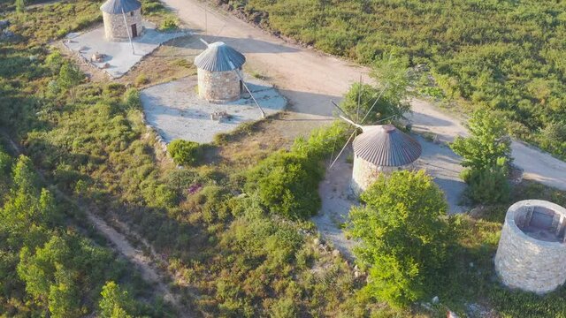 Aerial view The ancient windmills, Portugal. This is typical windmills, located in the on the hills in Portugal.
Circular tower mill has four trapezoidal sails made of wood. The four lattice framework
