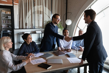 Employer, hr managers welcoming new employee to team, giving handshake to candidate at job...