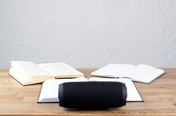 Portable audio speaker. Audio column on books. Digital excellence concept on q books.