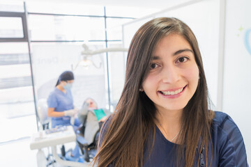 Young female professional dentist in her office.