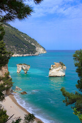 Fototapeta premium The most beautiful beach of Italy: Zagare (or Mergoli) Bay in Apulia. The beaches offer a breathtaking view with white karst cliffs,emerald blue sea, lush greenery of olive trees, pine woods.