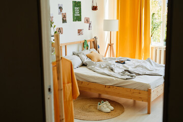 Background image of cozy teenage bedroom interior in sunlight with a lot of accessories and comfortable bed, copy space