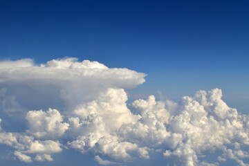 Naklejka na ściany i meble Blue sky with clouds. Dramatic heavenly landscape of white clouds on background of blue sky
