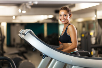 happy girl walking on a treadmill