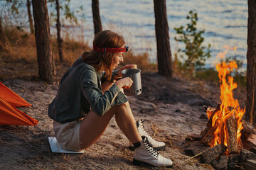 Hiker enjoying the smell of tea at campfire