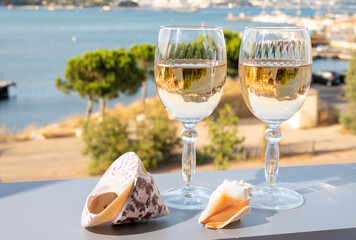 Summer on French Riviera, drinking of cold white or gris rose wine from Cotes de Provence on...