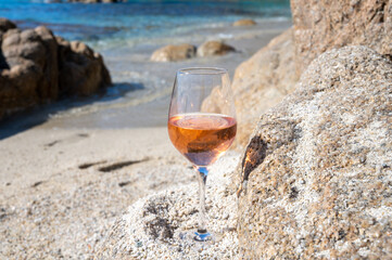 Summer time in Provence, glass of cold rose wine on sandy beach near Saint-Tropez, Var department, France