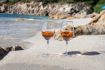 Summer time in Provence, two glasses of cold rose wine on sandy beach near Saint-Tropez, Var department, France
