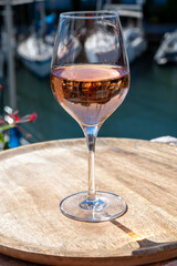 Summer on French Riviera Cote d'Azur, drinking cold rose wine from Cotes de Provence on outdoor terrase in Port Grimaud, Var, France