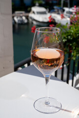 Summer on French Riviera Cote d'Azur, drinking cold rose wine from Cotes de Provence on outdoor terrase in Port Grimaud, Var, France