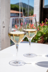 Summer on French Riviera Cote d'Azur, drinking cold dry white wine from Cotes de Provence on outdoor terrase in Port Grimaud, Var, France