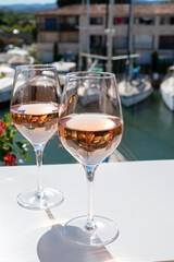 Summer on French Riviera Cote d'Azur, drinking cold rose wine from Cotes de Provence on outdoor terrase in Port Grimaud, Var, France