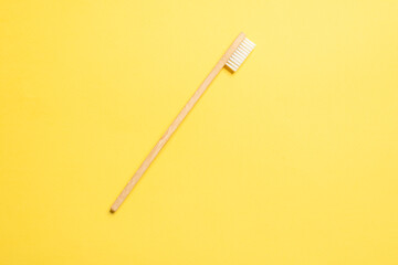 Bamboo toothbrush on a blue background.