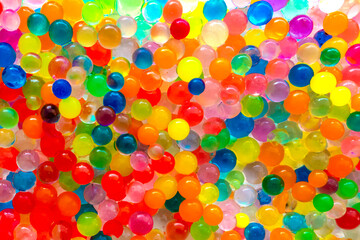 The texture is a lot of different color balls. Set of multi-colored orbeez. Many multicolored orbits