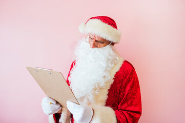Man dressed as Santa Claus with a notebook