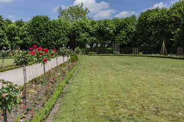 Colourful public garden and a small pond with goldfish and water lilies near Episcopal Palace (Bishop's palace). Meaux, Seine-et-Marne department, Ile-de-France, metropolitan area of Paris, France.