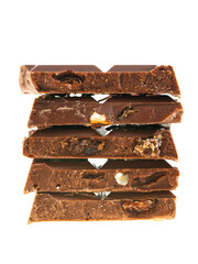 Stack of milk chocolate pieces with nuts and raisins on white background 
