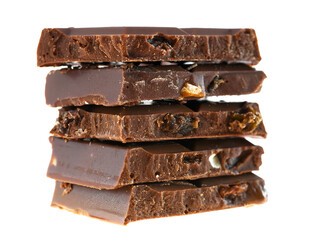 Stack of milk chocolate pieces with nuts and raisins on white background 