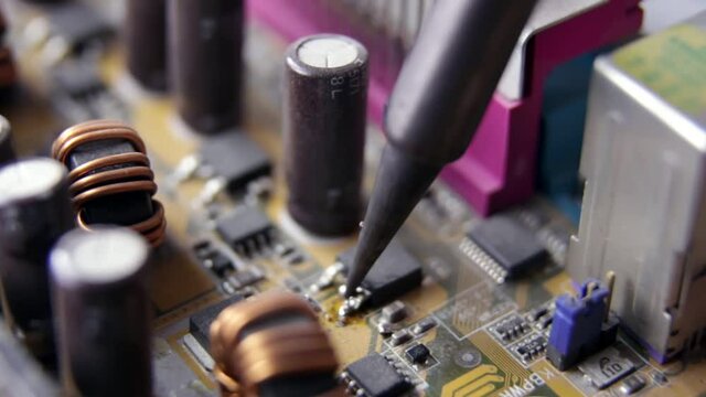 Soldering of electronic circuit board with electronic components. Soldering station. Engineers repair circuit board with soldering iron. Computer repair concept