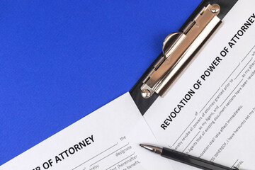 Revocation of power of attorney form. Office desk and clipboard with agreement. Top view photo