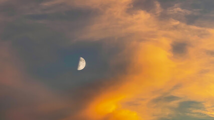 RIGA, Latvia in July: warm sunset with large new moon