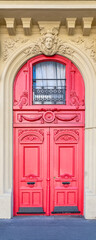 Paris, an ancient red door, typical building in the 11e arrondissement
