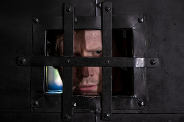 Hands of man catch in the iron prison. Man in prison, hope to be free. Crime - Prison Cell...