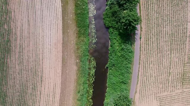Aerial view on a flight over a river between two fields