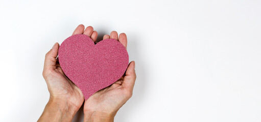 Red paper heart in woman's hands on white background