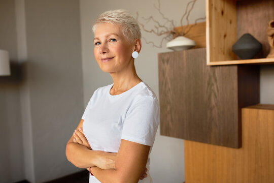 Smiling Beautiful Lady Specialist Posing With Crossed Hands In Cabinet. Professional Masseuse Ready For Session. Massage Room, Total Relaxation, Body Care, Wellness Concept