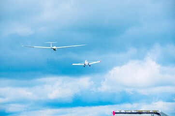 Propeller plane towing glider in sky, at Harris Hill, Elmira, New York - known as the “Soaring...