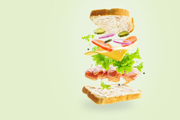 On a plain white background, a sandwich in a state of levitation. Abstraction. Minimalism. There are no people in the photo. There is an empty space for your insert.