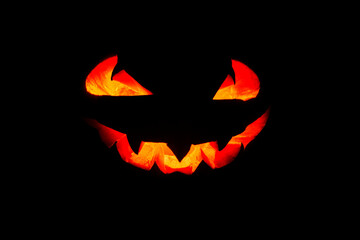 Glowing eyes and mouth of halloween pumpkin (Jack o lantern) on black background. Halloween