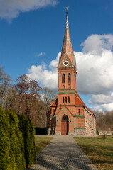 Fototapeta na wymiar Church St. Thomas (Kościół św. Tomasza), built at the turn of the 14th and 15th centuries, rebuilt in 1860. Brick tower from 1882, neo-Gothic. Runowo (village in Lobez County), Poland.