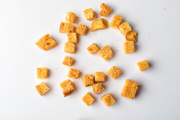 Square breadcrumbs. Oven-fried golden brown bread crumbs. White background