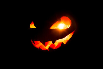 Glowing eyes and mouth of halloween pumpkin (Jack o lantern) on black background. Halloween