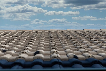 Fototapeta premium Grey terracotta roof tiles in a line on a roof