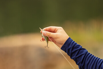 White young boys hand holding a fishing lure