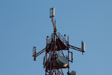 Telecommunication towers with wireless antennas on sky background. Cellular phone antenna.