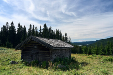 House of Knaiseter summer farm in Hurdal, Akershus, Norway. Skrukkelisjøen Lake to be seen in the background.