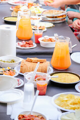Table full of food for a party. Food in plates and glasses to serve.