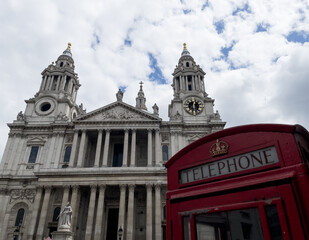 Fototapeta na wymiar St Pauls Cathedral and Red telephone box booth on Cloudy blue sky London